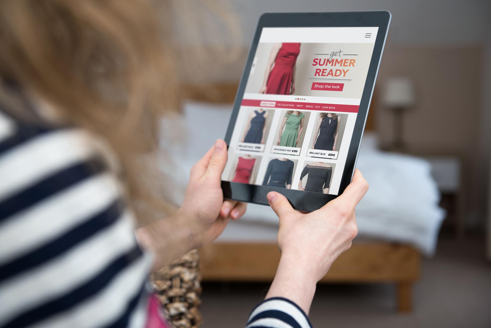 Woman is looking and shopping at website template for fashion online shop.